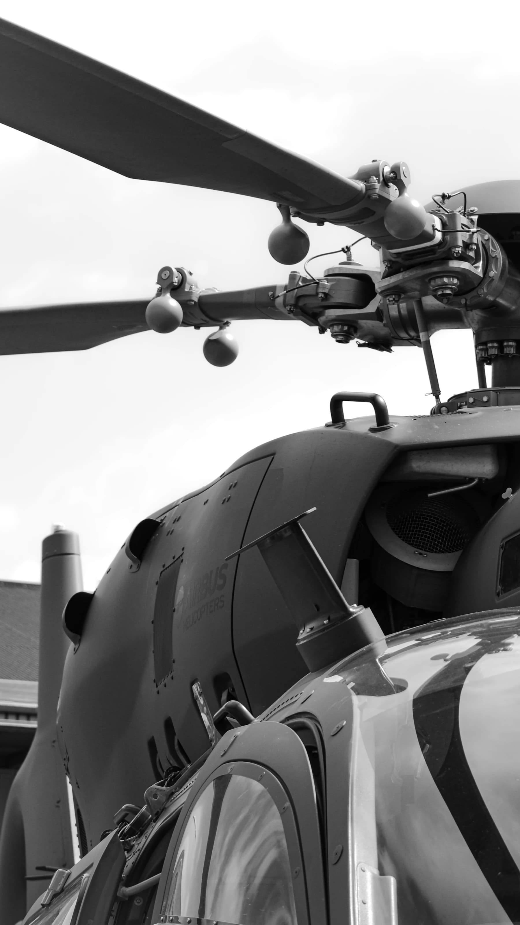 Close-up of a helicopter rotor assembly and fuselage