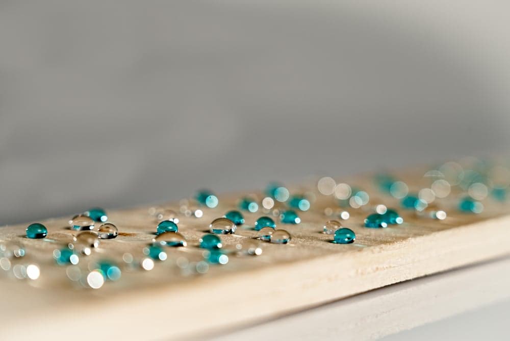Close-up of water beading on a natural wood sample
